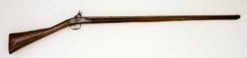 rifle with wood stock pointing right