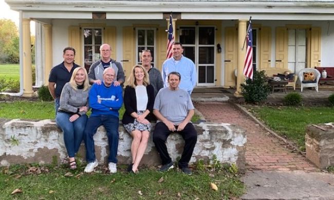 Board of directors group photo in front of Penrose-Strawbridge House