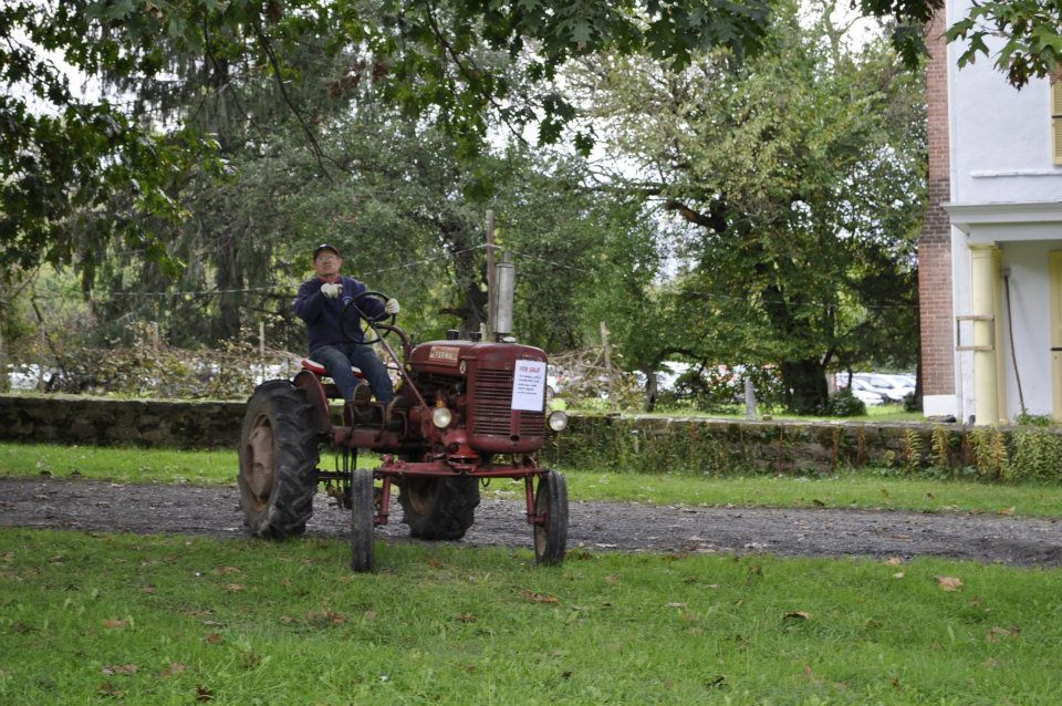 photo of Pete Choate riding old red tractor