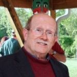 image of peter choate in red turtleneck and blue blazer